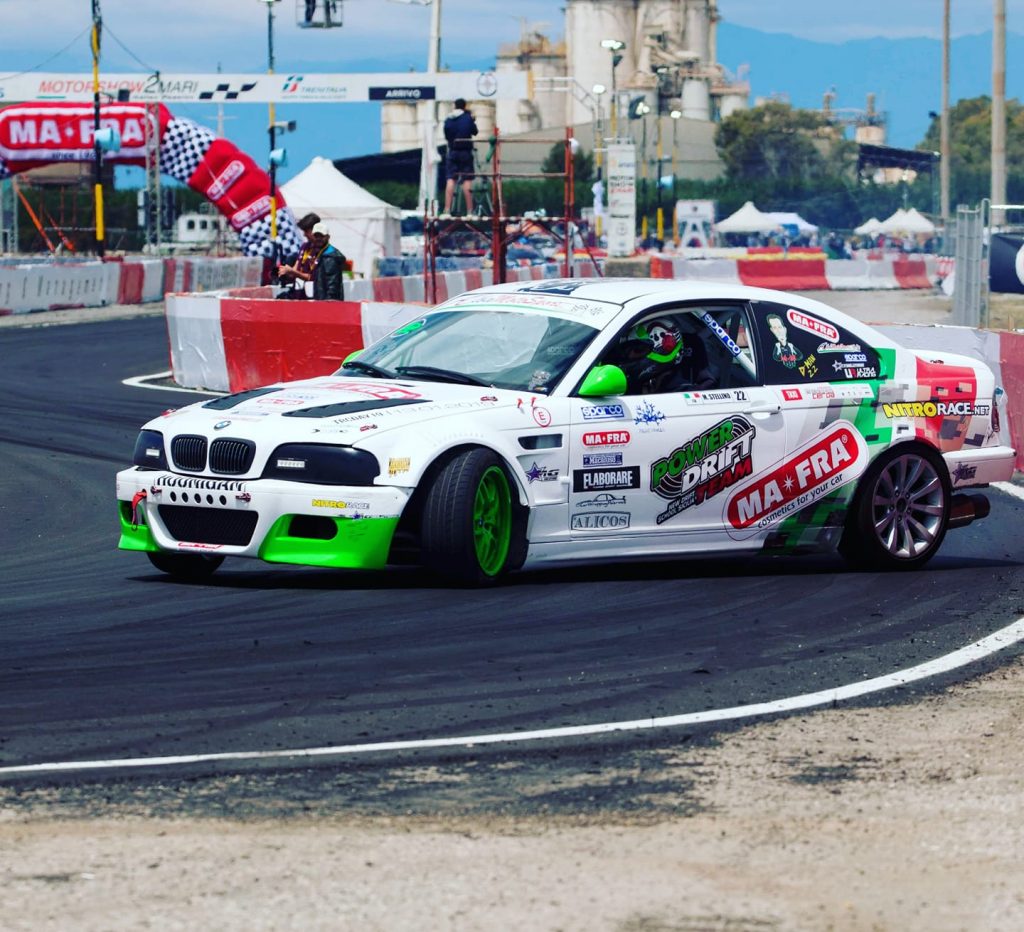 Auto in sovrasterzo, sovrasterzo di potenza innescato volutamente durante una esibizione di drifting